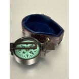 A brass cased pocket compass with green dial with lower section of original case, ( D  x 4 cm)