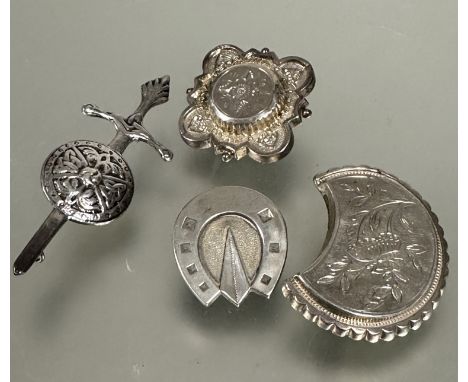 A Edwardian Birmingham silver square panel shaped brooch, a white metal crescent shaped brooch, a white metal horse shoe broo