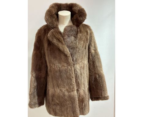 A Lady's Musquash fur jackets with folded collar and slash pockets to side and satinised lining and label for Afton Seftor Ed