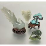 A turquoise carved Shubumkin with carved wood stand, slight losses to tail fin,( H x 3 cm x L x 5.