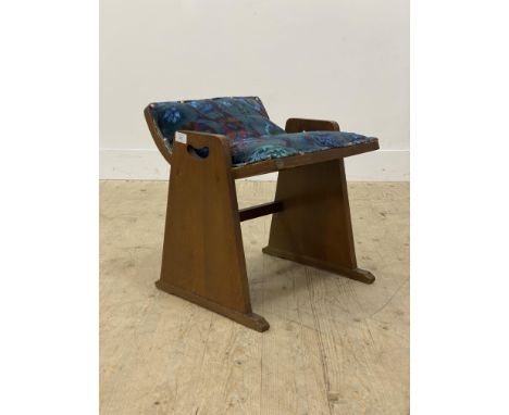 An Arts and crafts oak vanity stool, early 20th century, the dished seat upholstered in floral velvet, raised on splayed and 