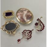 A Victorian gilt metal rococo style oval framed mourning brooch with oval glazed panel verso, (L x