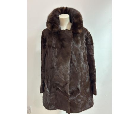 A vintage Astrakhan brown fur jacket with Mink faced collar, side slash pockets and satinized lining and A E Ball of Edinburg