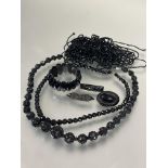 A  group of Victorian carved jet, including a graduated necklace, signs cracks, (L x 21 cm) two