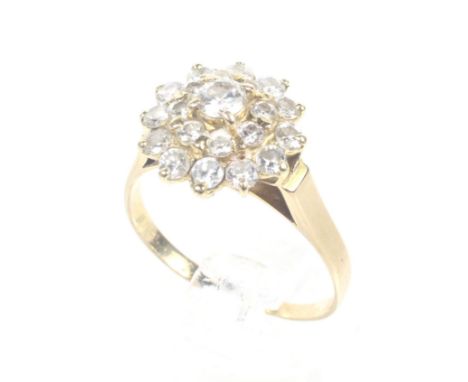 A vintage diamond cluster ring. The 21 graduated round brilliant diamonds approx. 0.90cts total, all claw set as a target clu