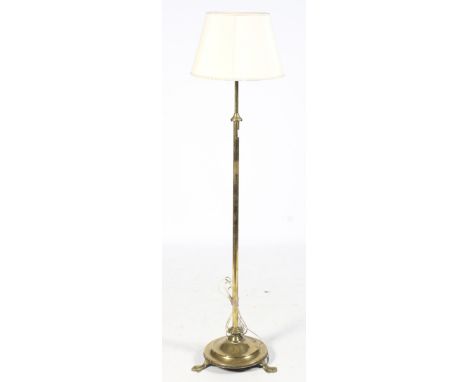 An early 20th century brass telescopic standard lamp. With circular step base and three feet, H144cm (contracted)