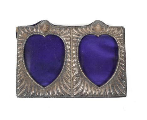 A Victorian silver-mounted double-hearts photograph frame. With a broad spiral-lobed 'hit and miss' surround and two vacant o