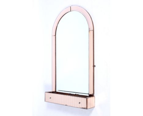 Art Deco : An original peach glass surround bevelled and arched wall mirror. With a trough to the front and bevelled edge fra