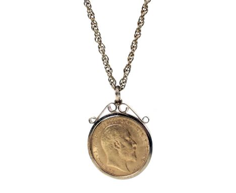 A Sovereign, 1910, loosely mounted in a plain 9ct gold pendant mount. Hallmarks for Birmingham 1975; this hung from a gold-pl