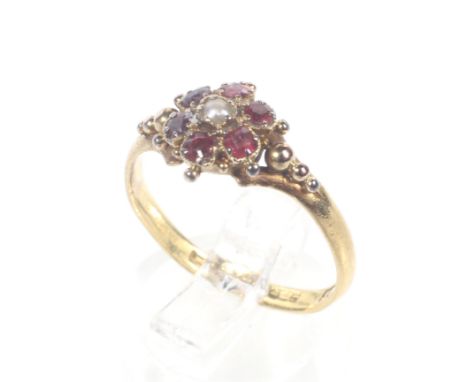 An early Victorian 22ct gold, ruby and half-pearl cluster ring. Centred with a small half-pearl within a round mixed-cut ruby