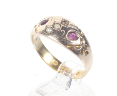 A late Victorian gold and gem set gypsy-type ring. The tapering band with a central seed-pearl diagonal band (one missing) be