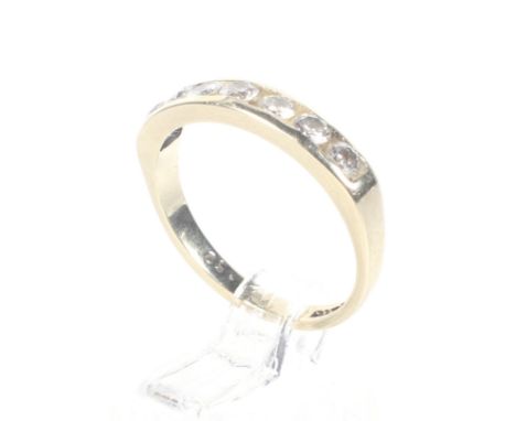 A vintage 9ct gold and diamond seven stone half-eternity ring. The round brilliant stones approx. 0.50cts total, channel set 