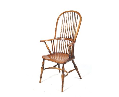 A contemporary ash Windsor stick back armchair. With a one piece ash seat, crinoline stretcher, turned supports to the Victor