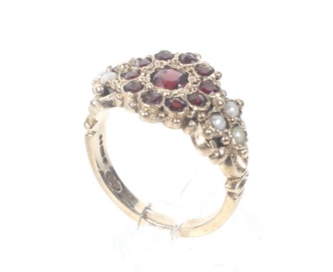 A vintage 9ct rose gold, garnet and half-pearl ring in Victorian style. With a central garnet cluster between half-pearl tref