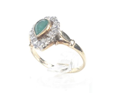 A vintage 9ct gold, emerald and diamond pear-shaped cluster ring. The central pear-shaped emerald rub-over set in yellow with