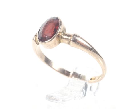 An early 20th century 9ct rose gold and small oval garnet single stone ring. Hallmarks for Chester 1919, size J, 1.3g gross