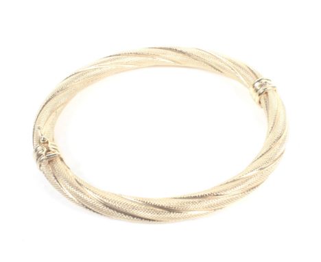 A vintage Italian gold textured spiral-twist hollow tubular hinged bangle. Italian marks and stamped '375', 9.3g Condition Re