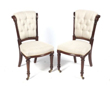 A pair of mid to late Victorian button back mahogany over stuffed 'knocker' chairs. 91.5cm high, 47cm wide, 50cm deep