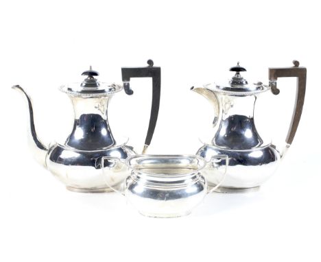 A vintage silver oval three piece coffee service. Each with a gadrooned rim, The coffee pot and hot milk jug with ebonised sc