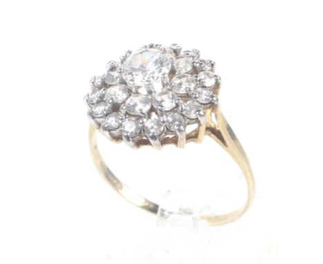 A vintage 9ct gold and cubic zirconia cluster ring. Int the form od a three-tier cluster, on a D-section shank with hallmarks