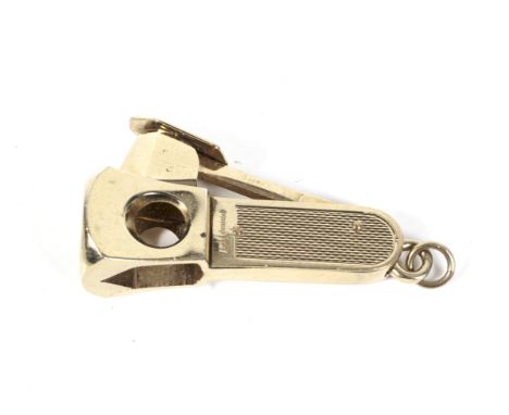 A 9ct gold mounted brass cigar cutter. The engine-turned gold panels with hallmarks for Birmingham 1972 by S J Rose, 6.5cm lo
