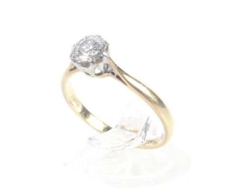 A vintage gold and diamond solitaire ring, circa 1960. The round brilliant approx. 0.30cts, grain set within a 'shaped' white