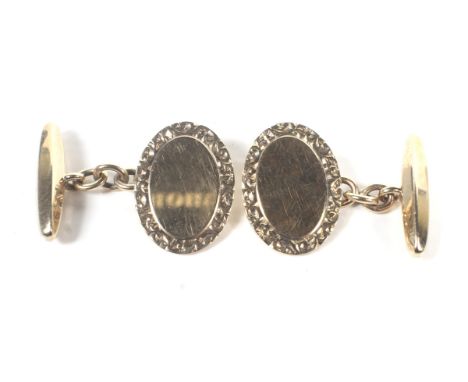 A pair of vintage 9ct gold cufflinks. Each with an uninscribed oval panel with a floral border and a facetted torpedo back-li