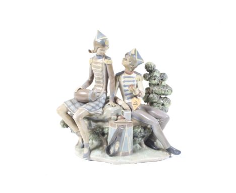 Lladro: a figure group depicting seated male and female in military orchestral uniforms. 29.5cm high, 30cm wide, 14cm deep, m