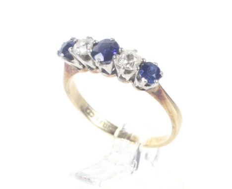 An early 20th century gold, sapphire and diamond five stone ring. The three graduated round mixed-cut sapphires spaced by old