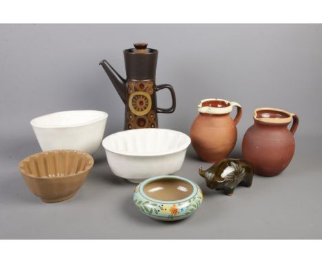 A small selection of ceramics. To include a Denby Arabesque coffee pot, three vintage jelly moulds, two terracotta jugs and W
