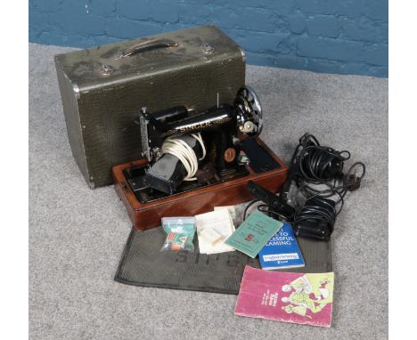 A 1930s Singer 99K sewing machine in case with accessories. Including mat, spare light, motor etc.  
