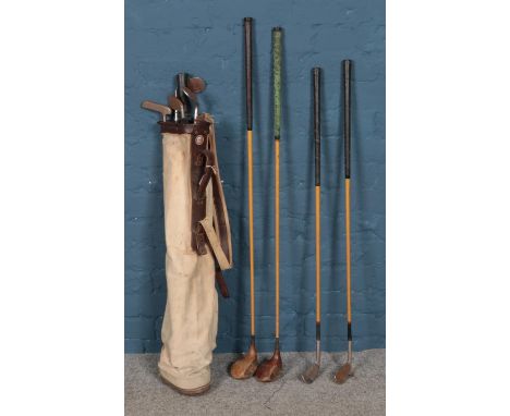 A selection of vintage golf clubs and Spalding canvas bag. To include Wright & Ditson, Spalding and Walter Hagen examples.  