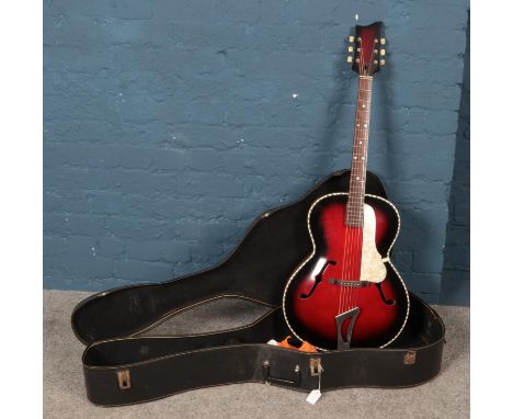 A vintage acoustic guitar in carry case.  Restrung.