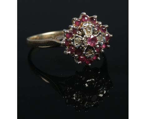 A 9ct gold ruby and diamond cluster ring. Size P 1/2. 2.9g.  
