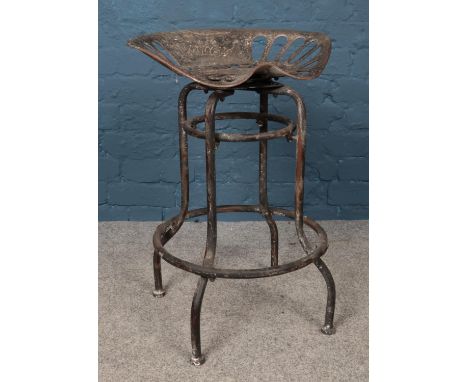 A Pan and Botany metal tractor seat bar stool. 66cm high.  