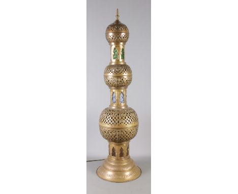 A large Eastern brass bulbous table light, with coloured glass panels. Height: 113cm.  In working order.