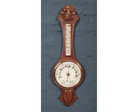 A carved oak Aneroid banjo barometer.  