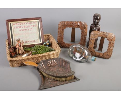 A basket of collectables. Includes Benin carving, ship in bottle, crumb scoop and brush, framed sampler etc.  