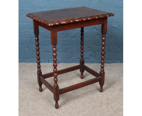 An oak occasional table with bobbin turned supports.  