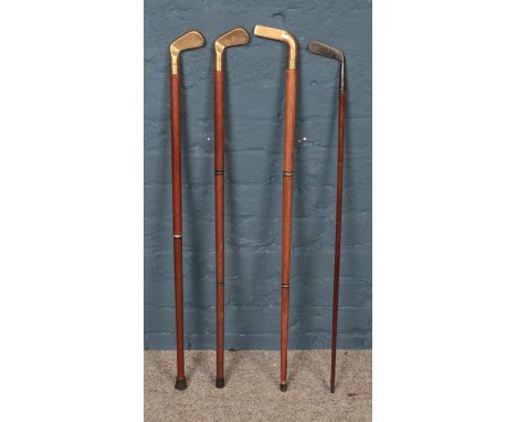 A collection of four vintage Sunday golfing sticks, to include putter and example containing drinking tube.  