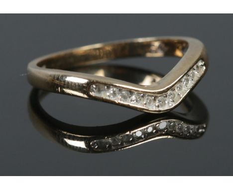 A 9ct Gold and Diamond wishbone ring. Size K. Total weight: 1.64g  Small stones missing from both sides.