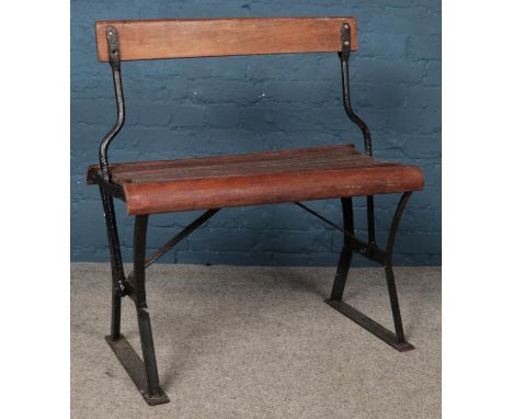 A vintage hardwood slatted two-way train/tram bench. Height: 86cm, Width: 78cm Depth: 42cm.  