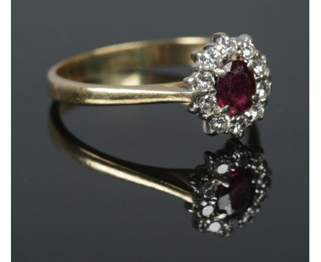 An 18ct Gold Ruby and Diamond cluster ring. Size P, Total weight: 3.29g.  