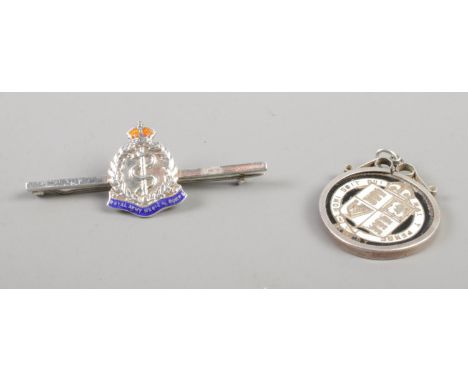 A sterling silver bar brooch for The Royal Navy Medical Corps, together with a Victorian and enamel coin set in white metal m