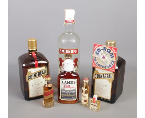 A collection of full and sealed bottled alcohol. Includes Smirnoff Vodka, Cointreau, Whisky miniatures etc.  