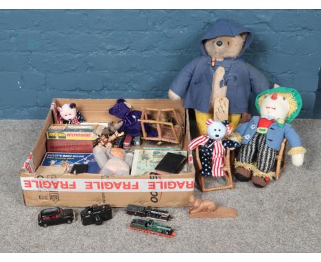 A large box of miscellaneous toys, to include annuals, die cast vehicles and vintage Paddington Bear (A/F).  