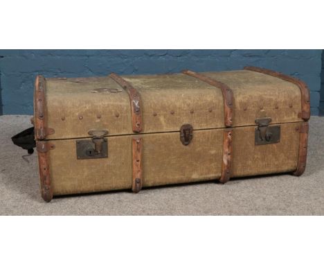 A wood bound canvas trunk, with pull out interior. Height: 34cm, Width: 86cm, Depth: 53cm.  Replacement handles have been add