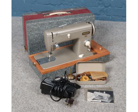 A vintage Pfaff No. 60 sewing machine with accessories.  