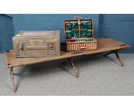 A WWII camp bed, together with ammunition box and picnic hamper.  