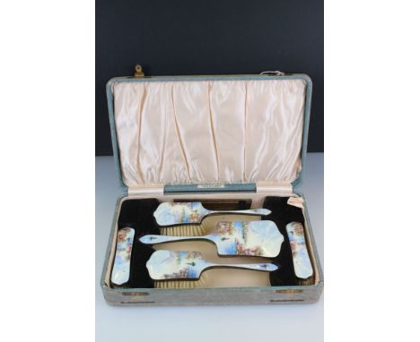 A mid 20th century silver plated brush and mirror vanity set with detailed enamel decoration and contained within original fi